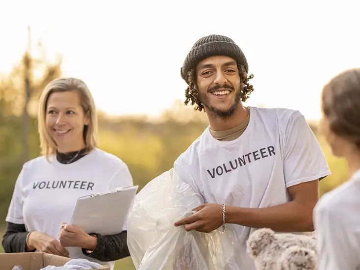 Three volunteers working together to better the community they live in.
