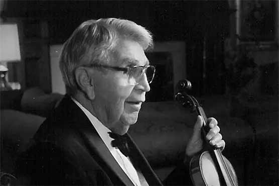 Green Bay Packaging's founder George Kress, holding on to a violin.