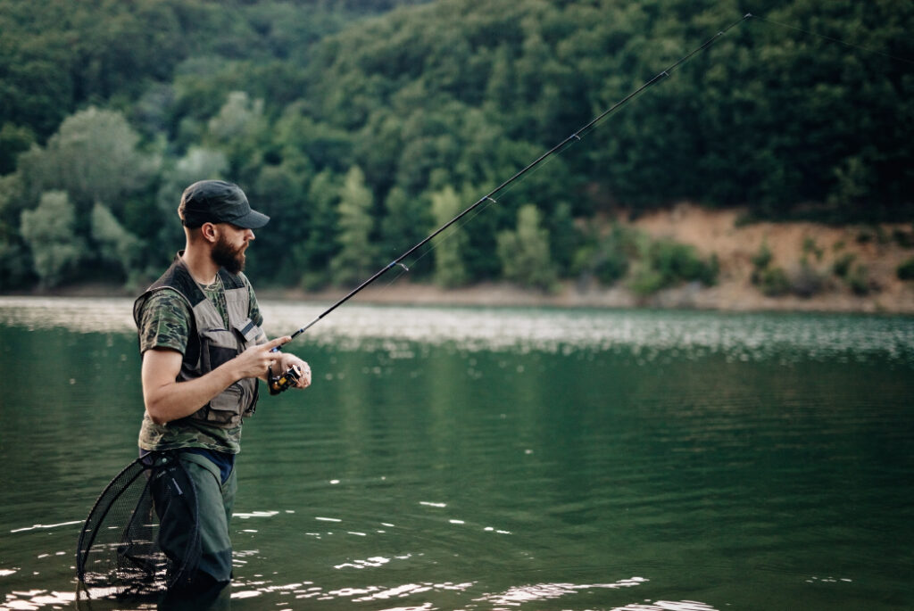 Man fishing in a river.