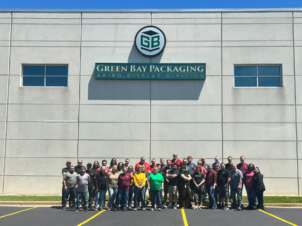 Team members from Green Bay Packaging’s Baird Display Division stand outside the facility, showcasing a committed workforce behind innovative packaging and display solutions.