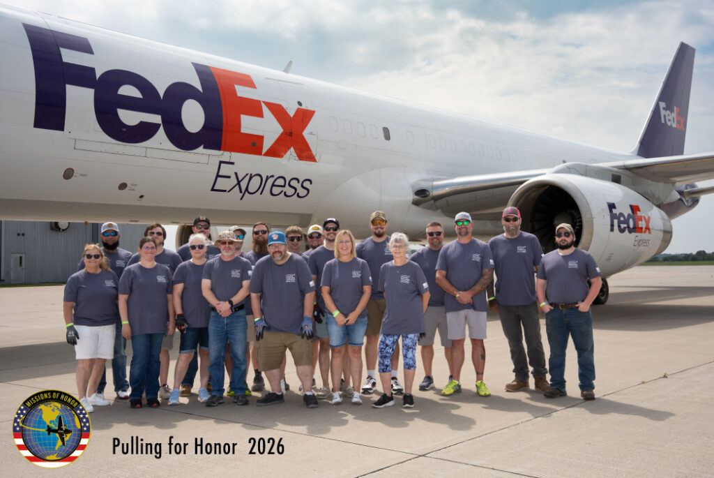 Green Bay Packaging employees participating in Pulling for Honor 2026, standing in front of a FedEx cargo aircraft to support veteran causes and military community initiatives.